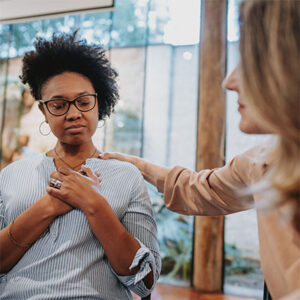 one woman comforting another woman as she experiences some powerful emotions.