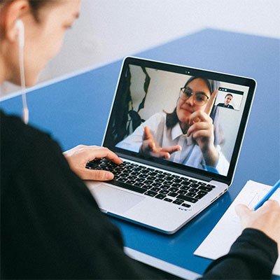 woman on virtual video call speaking with client.