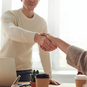 coach shaking hand with client